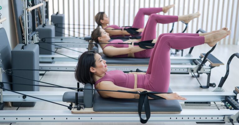 Women doing Pilates exercises with fitness balls during a class in New York City